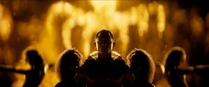 In a still from the film's title sequence, the silhouette of a shirtless Daniel Craig is surrounded by the silhouettes of various beautiful women. Behind him is the shape of a glowing golden octopus: the symbol of SPECTRE.